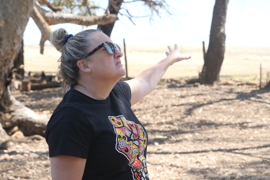 a woman looking up to the sky in appreciation