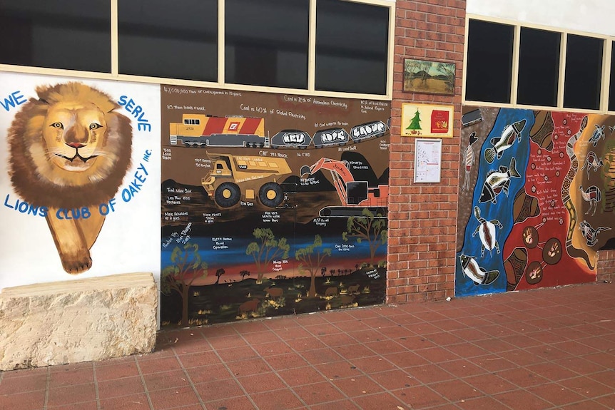 A mural on a wall depicting a mine in a local area