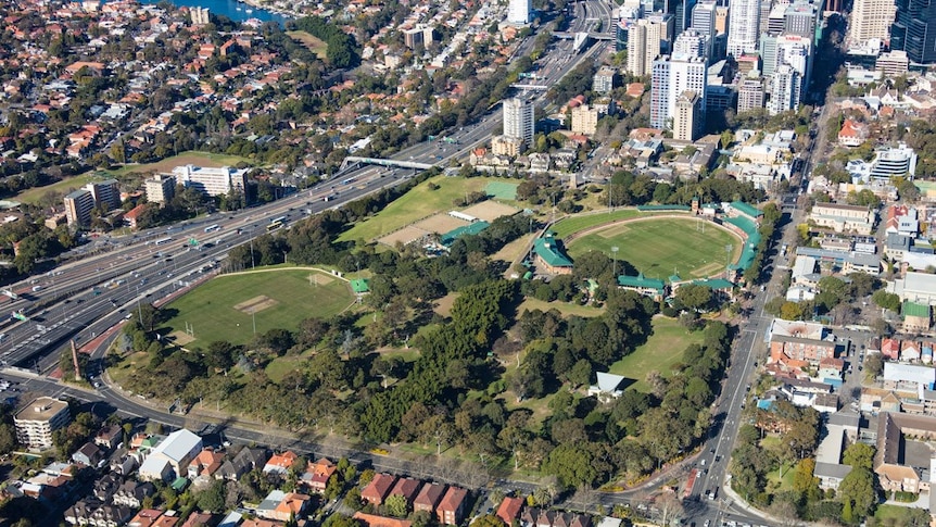 an aerial view of a park and high rise buildings