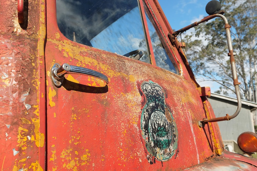 A rusty sign saying Bellbrook on the side of an old truck.