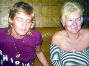 Rose Black sits next to her then-girlfriend, the Perth brothel madam Shirley Finn, on a couch.