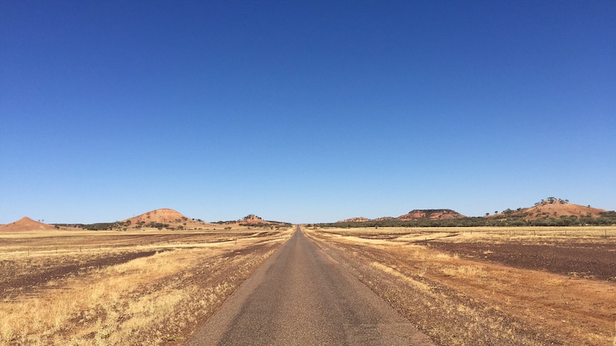 A long stretch of straight road in outback Queensland.