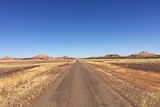 A long stretch of straight road in outback Queensland.