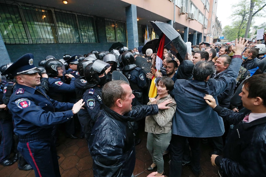 People gather in front of Ukrainian Interior Ministry security forces in Odessa