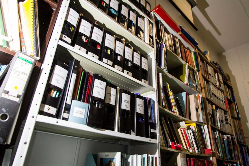 A bookcase full of historical records.