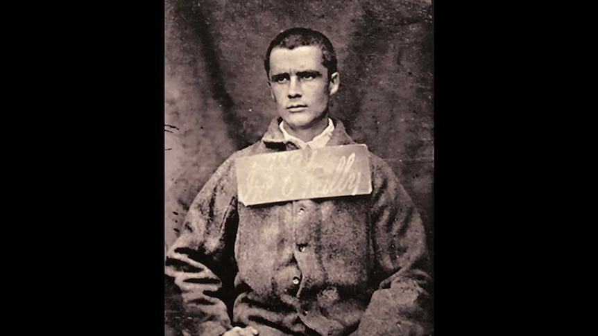 A photo of prisoner with identification label around his neck