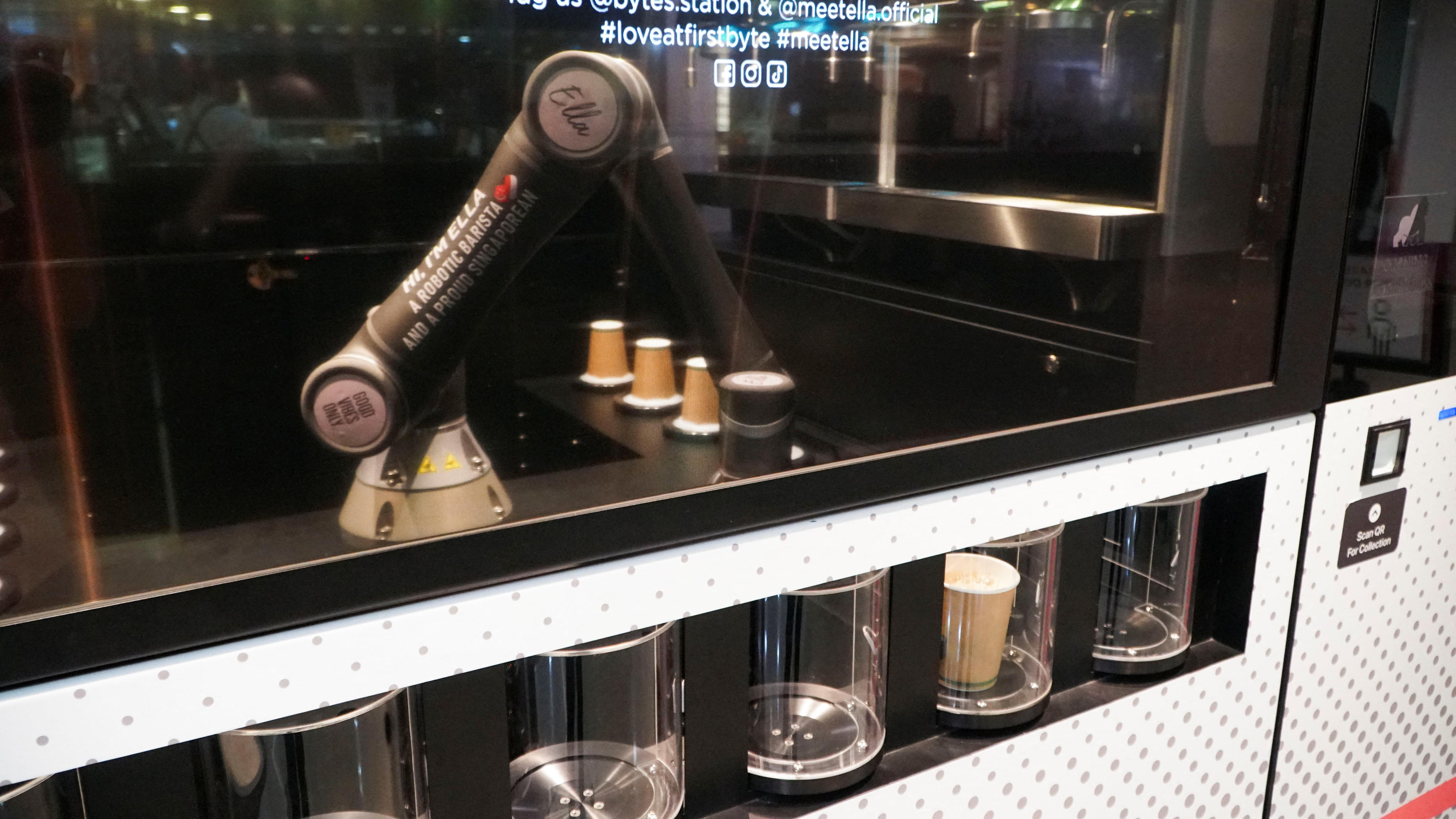 Robot coffee maker prepares coffee for commuters.