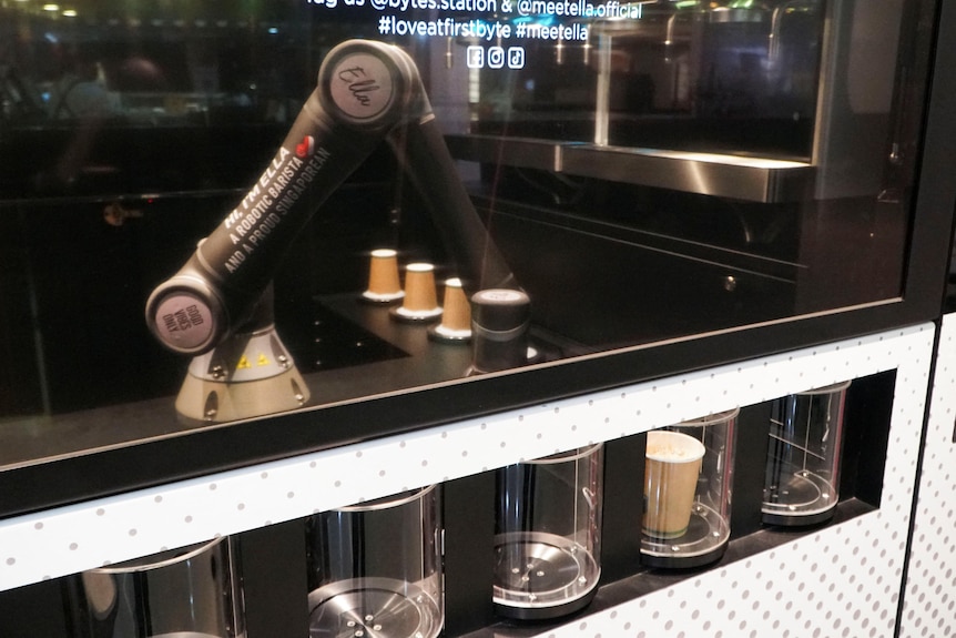 Robot coffee maker prepares coffee for commuters.