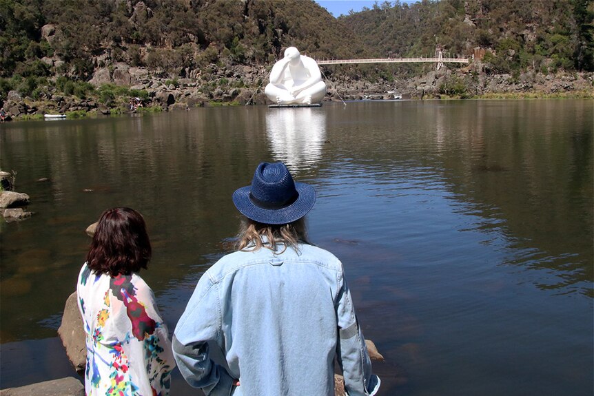 Two people look at an inflatable sculpture at Launceston's gorge