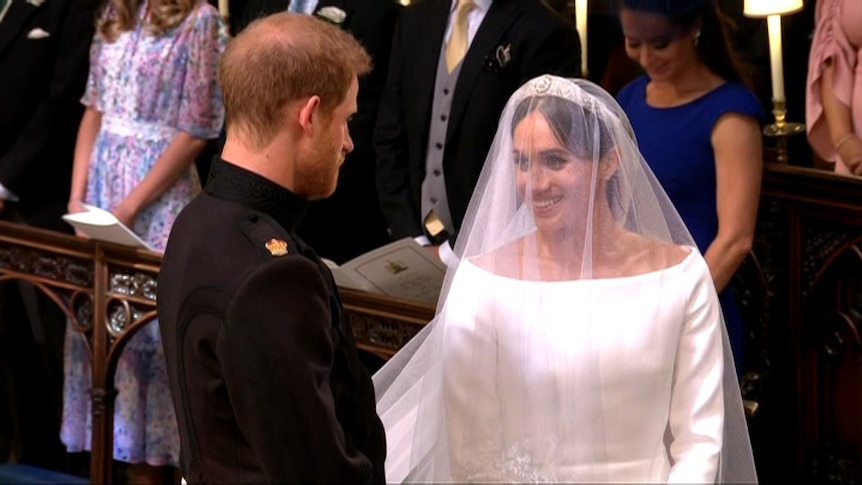 Prince Harry and Meghan Markle stand at the altar.