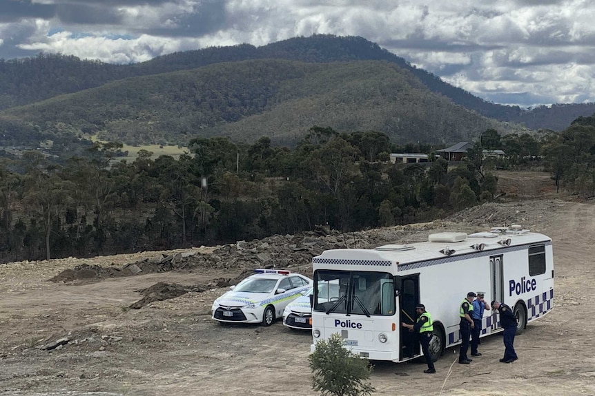 A police van with bushland in the background