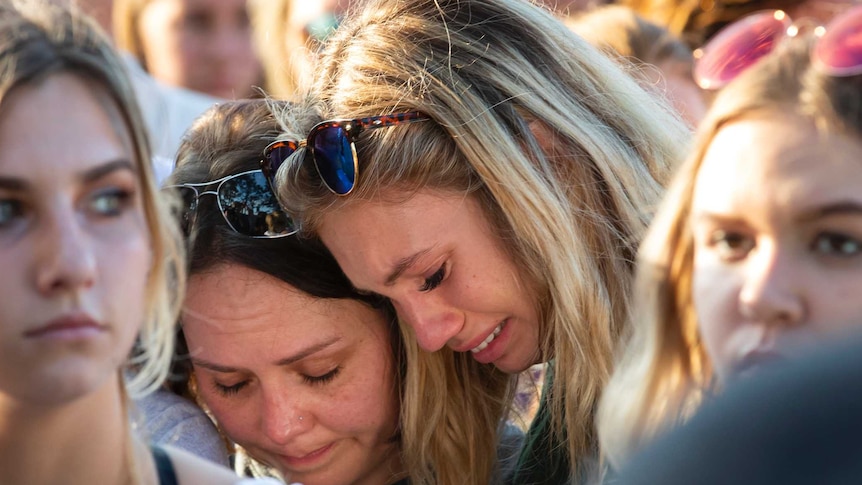 Women embrace during a prayer vigil