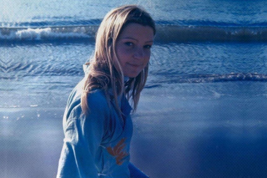 Head and shoulders picture of young woman with beach in background