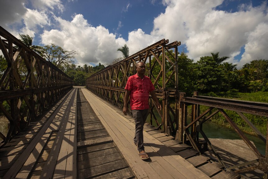 A man walking on a bridge.