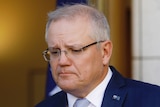 Scott Morrison frowns during a press conference.