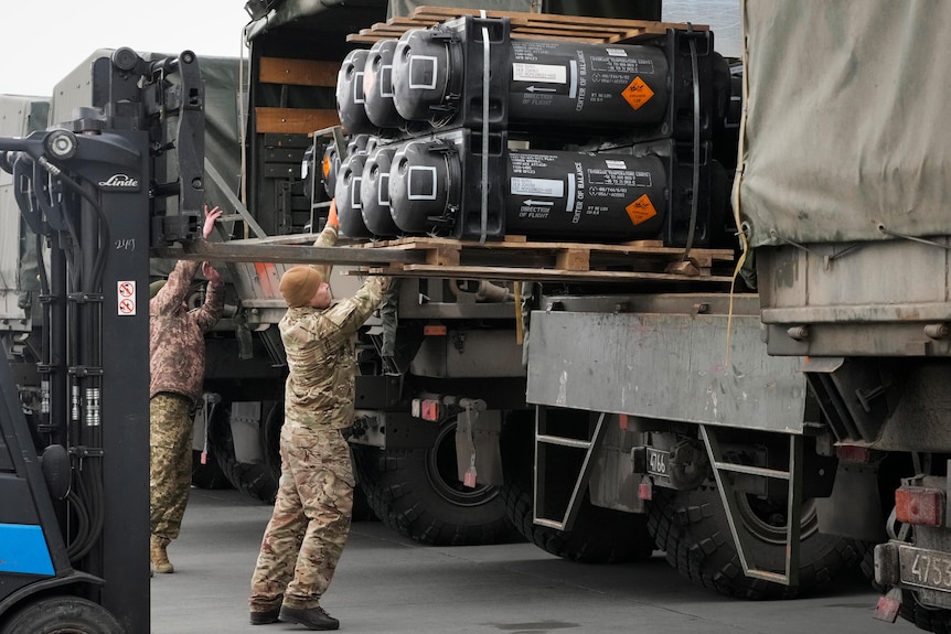 Ukrainian servicemen load Javelin anti-tank missiles, delivered from the United States