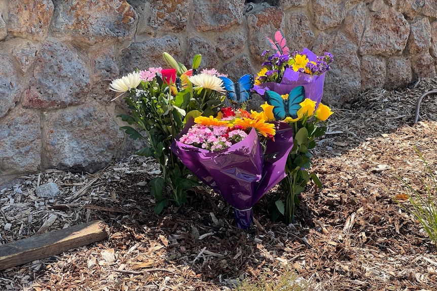 Flowers laid against a wall