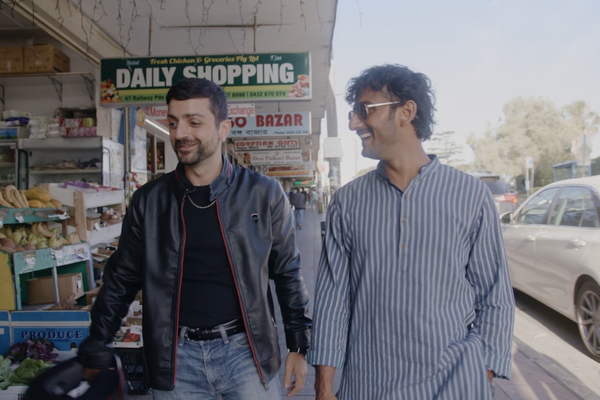 Two men walking and smiling