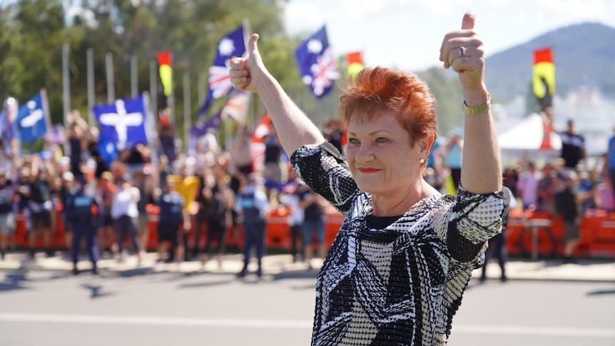 Pauline Hanson raises her arms at a rally in Canberra in February 2022.