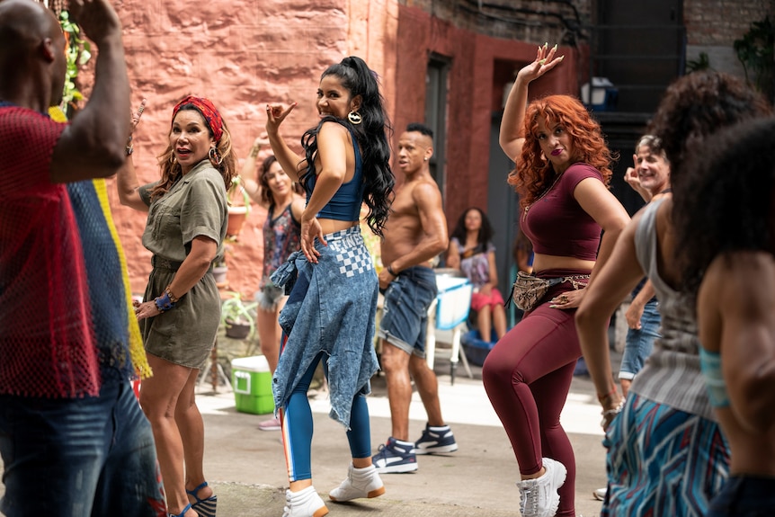 A group of young Latina women dancing in a street in In the Heights