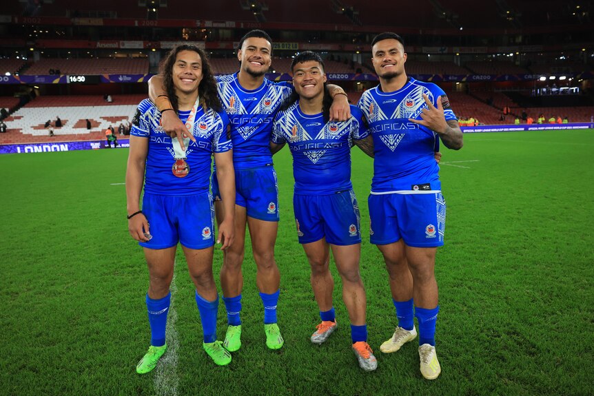 Jarome Luai, Stephen Crichton, Brian To'o and Spencer Leniu stand arm in arm after Samoa beat England at Rugby League World Cup.