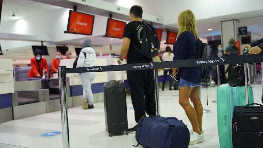 People at check in in Sydney International airport.