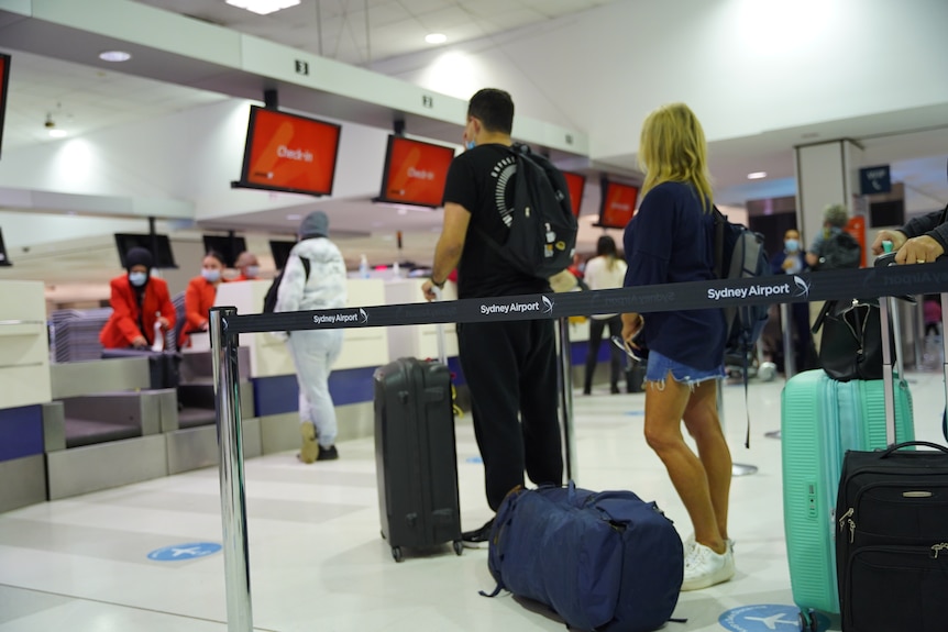 People at check in in Sydney International airport.