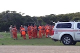 Police and SES crews gather to begin a search of the Coorong campsite