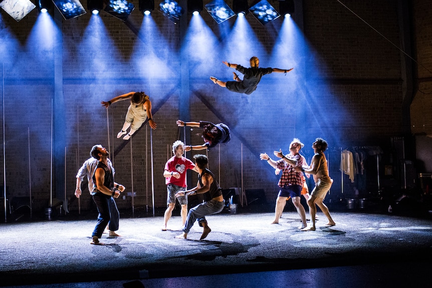 Three acrobats at different leaves after being tossed in the air.