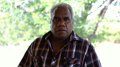 Tony Wurramarrba stands in front of trees.