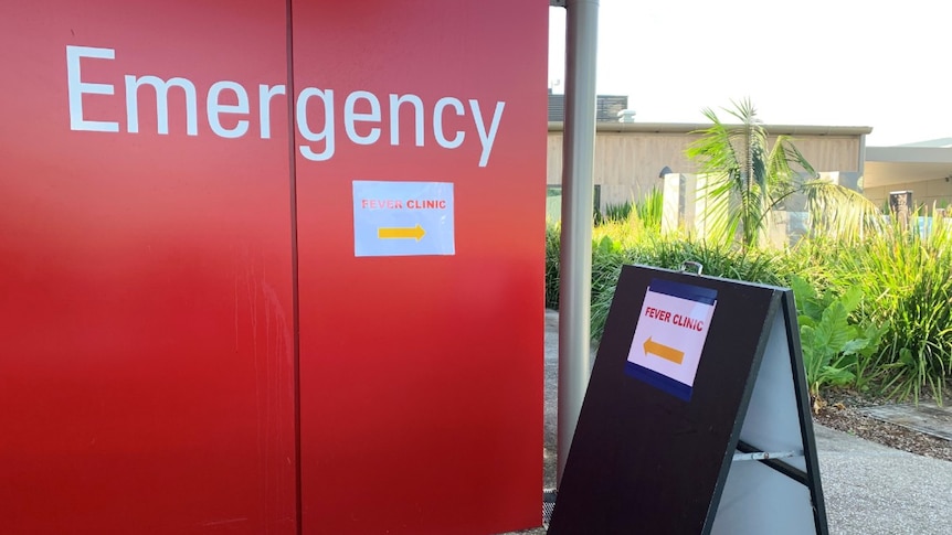 A red wall with 'Emergency' and a sign saying 'Fever clinic'