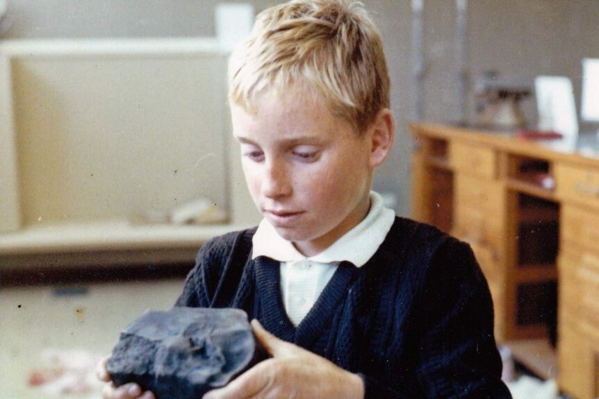 A young Peter Gillick holding a piece of the meteorite in his home in Murchison.