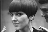 A close up, black and white image of a petite framed woman with a short bob cut.