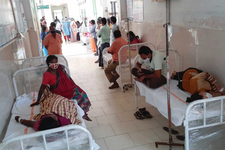 Patients and their bystanders are seen at the district government hospital in Eluru.