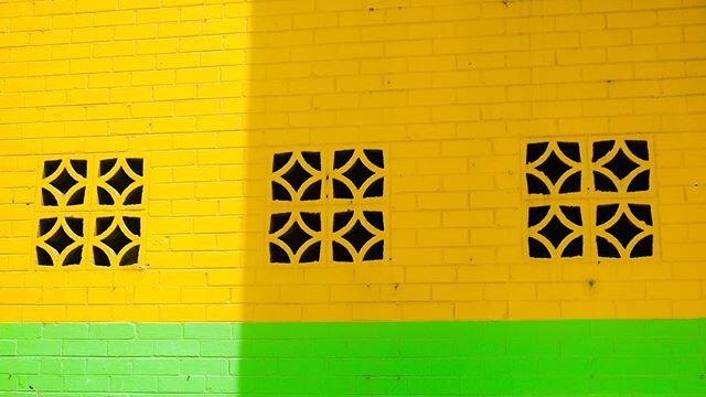 A wall is painted half green, half yellow.