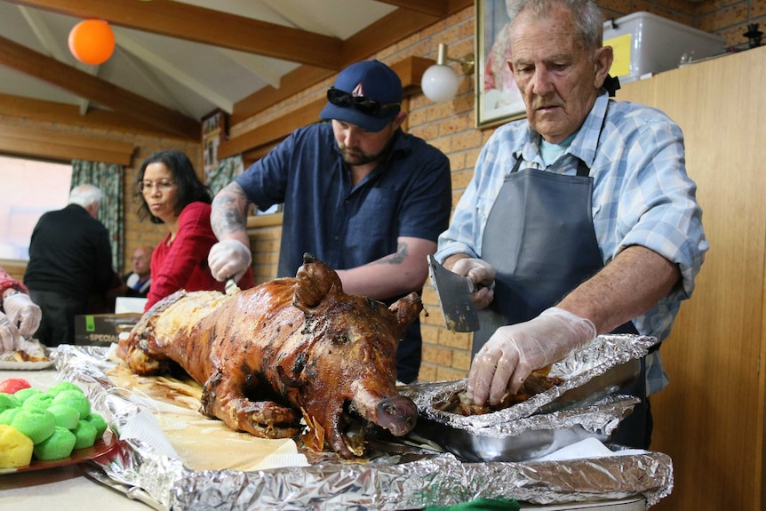Church-goers cutting up pork.