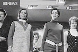 Black and white still frame from video showing women practicing deportment.