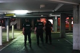 Three police officers walking in an underground car park