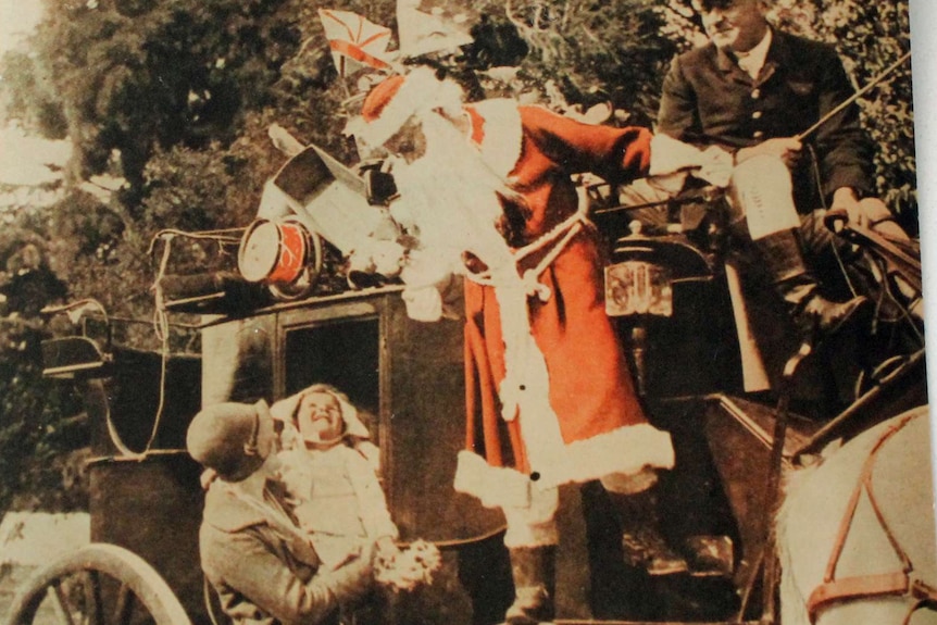 Archive photo of a young child looking up at Santa