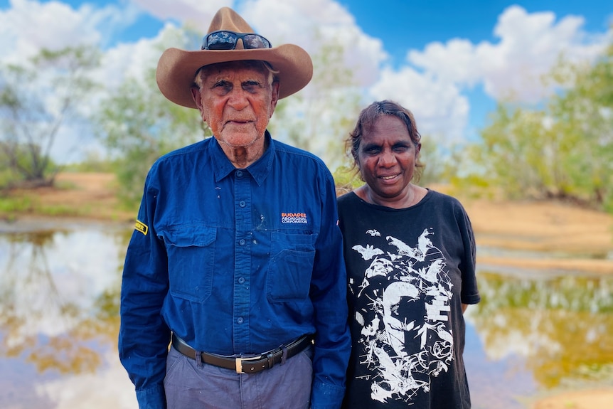 Stephen Stewart and Margaret Stewart with water and trees in background. 