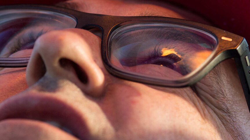 A lick of flame reflects in the lens of pilot Chris Shorten's glasses.
