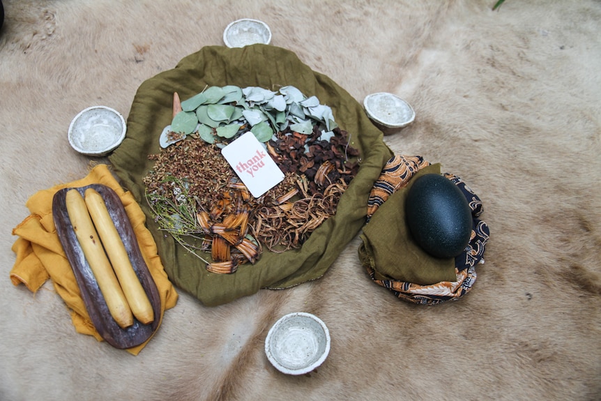 Clapsticks, an emu egg and healing tea served in ceramic vessels
