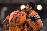 Two Brisbane Broncos NRL players lean on each other after losing a match to the Raiders in Canberra.