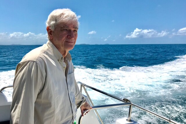 Marine researcher Eddie Hegerl looks at the ocean on a boat at Ellison Reef on the Great Barrier Reef off north Queensland.