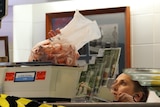 A bag of prawns being weighed