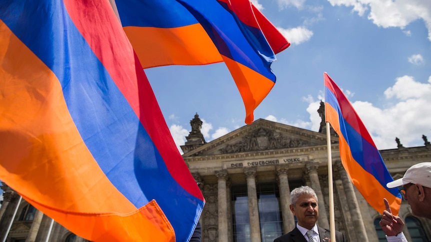 Armenian activists wave flags outside the German Bundestag after law makers voted to recognise the Armenian genocide.
