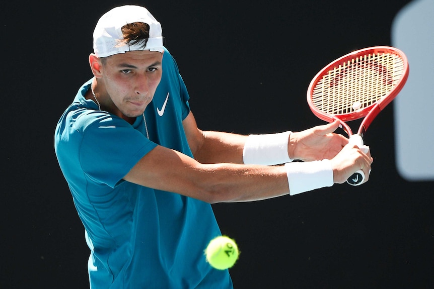 Alexei Popyrin plays a backhand return at the Australian Open.