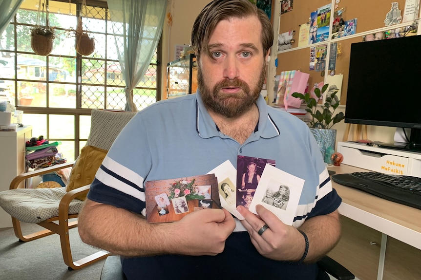 Heath holds photos of his mum with a sad expression