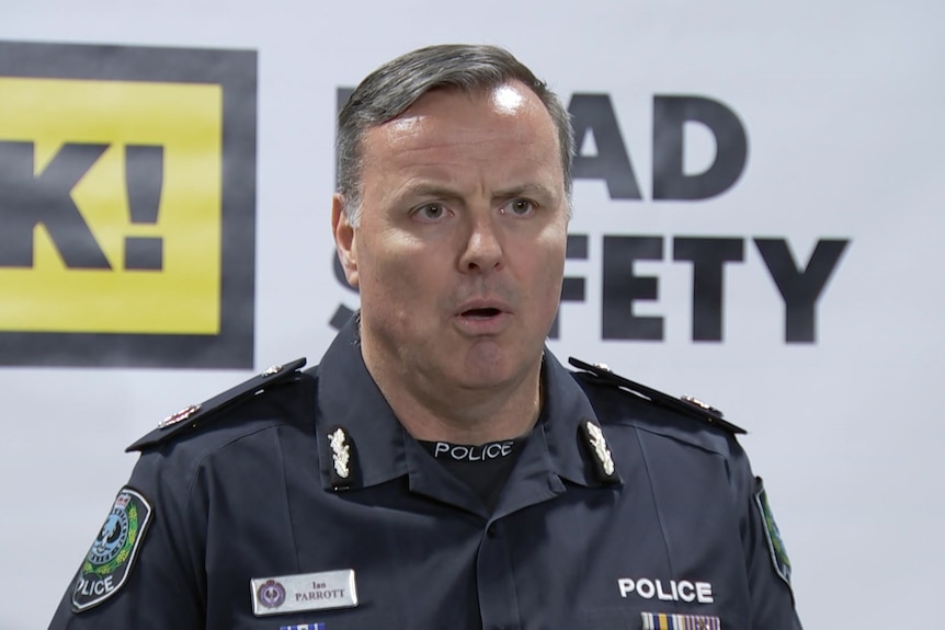 A man in a police uniform speaking