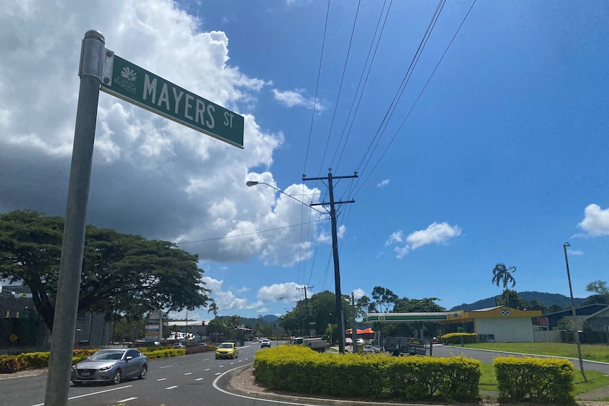 A green street sign saying 'Mayers street' and a long, mult lane road